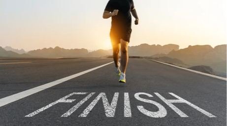 Finish line visual or beginner runner completing a park run